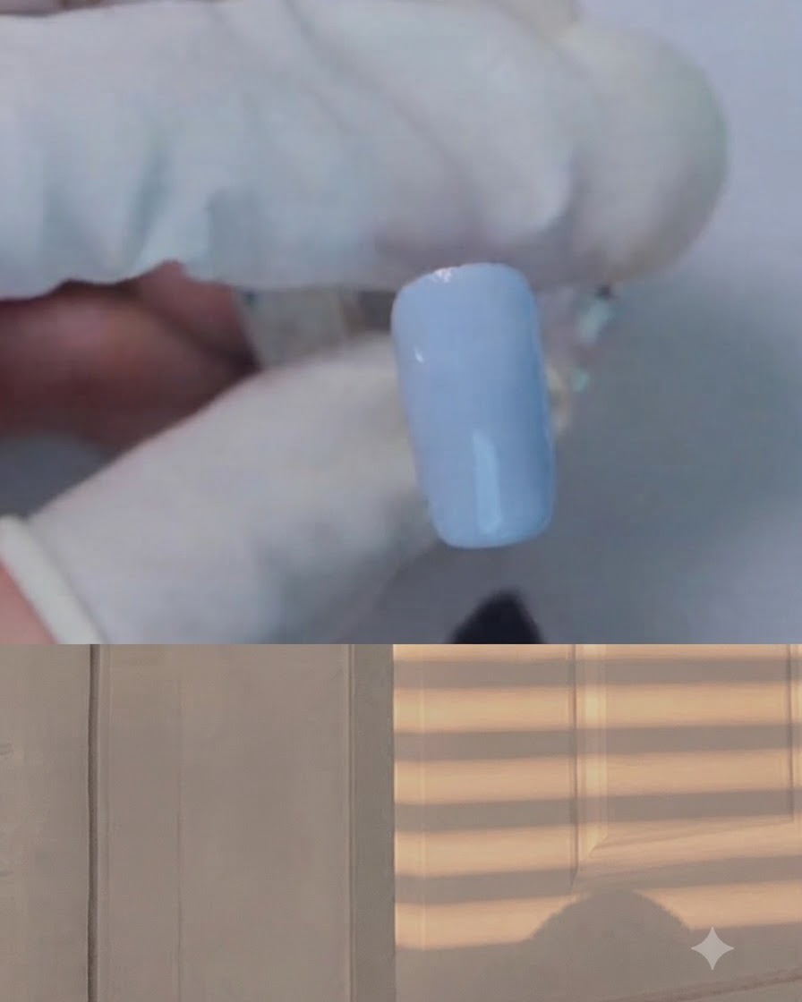 A brush applying clear blooming gel over a light blue nail.