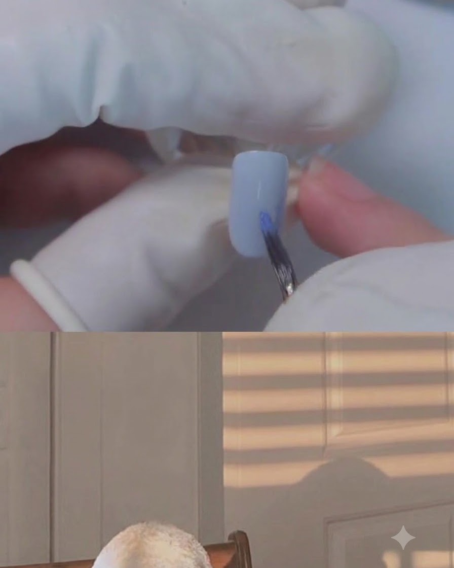 A fine brush applying color onto the pinky nail with blooming gel.