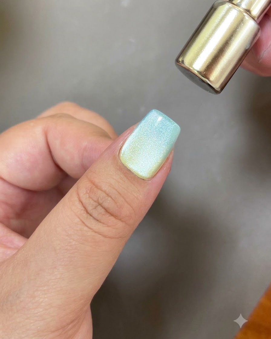 The rounded end of a magnetic tool hovering over a nail to create a circular cat eye reflection.