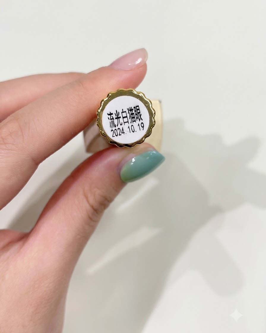 A nail brush evenly applying translucent white cat-eye gel polish onto a prepped nail.