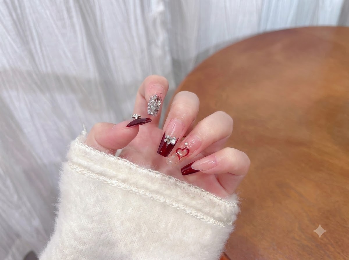 A hand shifting position gracefully to display the high-gloss reflection of a finished manicure under soft lighting.