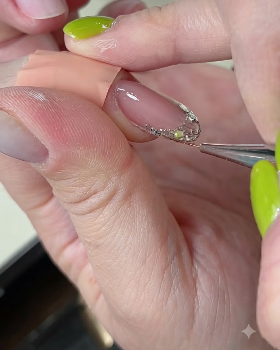 A fine liner brush smoothing and refining builder gel over a decorated nail extension.