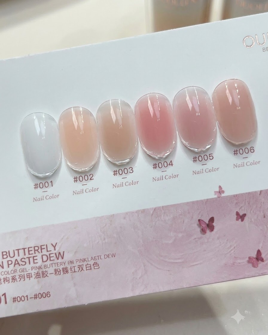A close-up shot of a bottle of milky white color building gel with the brush applicator pulled out, showing the fluid gel consistency.