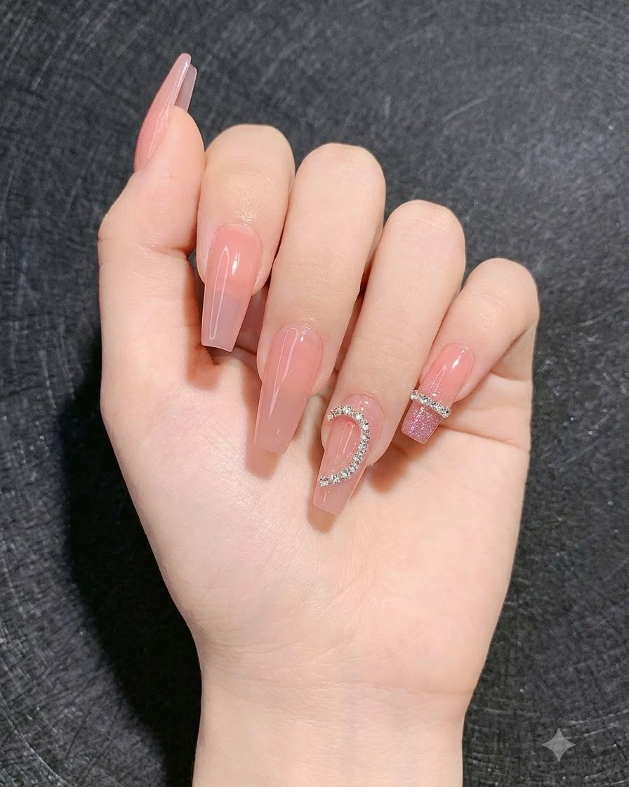 A hand showing completed nails with a sparkly disco gradient on the surrounding fingers and a heart rhinestone design.
