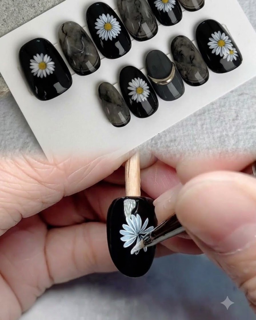 A detail brush painting a second overlapping layer of white petals on the daisy.