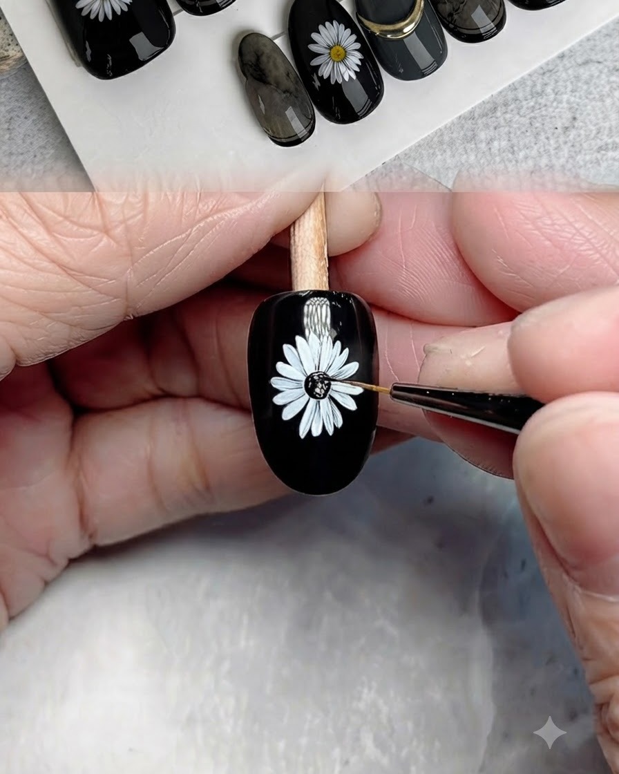 A fine brush applying black gel to the center of the painted daisy.