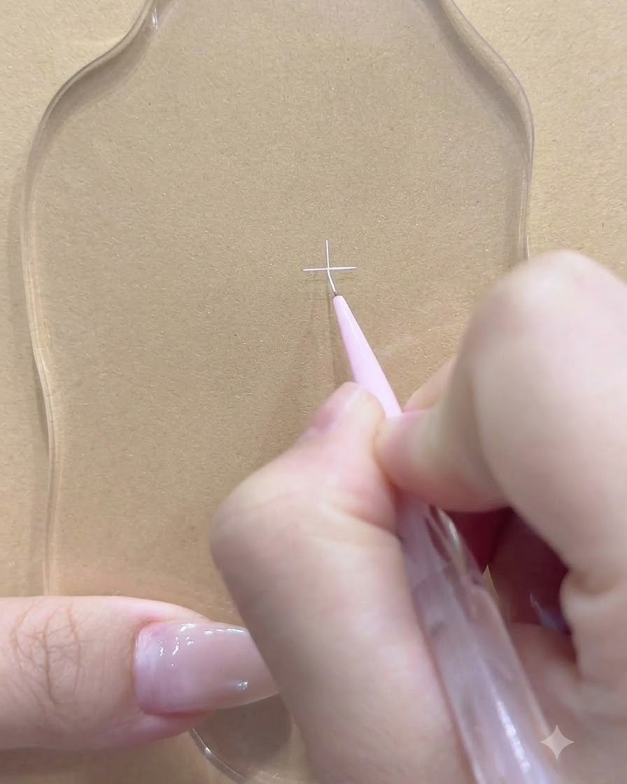 A fine liner brush adding an intersecting white line on the clear palette.