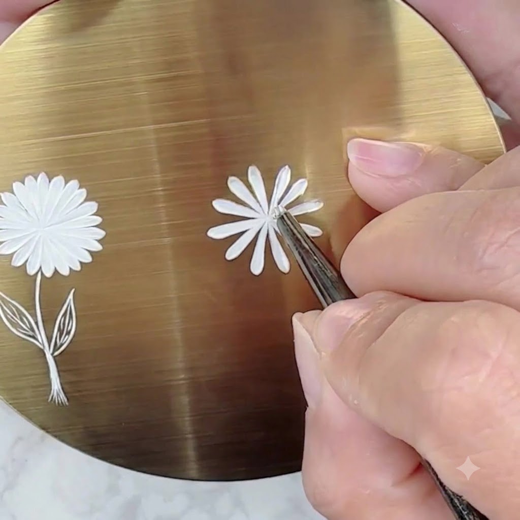 A golden practice surface showing a completed first layer of white daisy petals with distinct spacing between them.