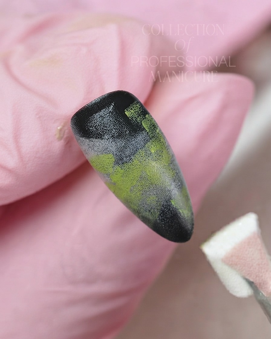 A fine liner brush applying white gel to paint a delicate five-petal flower on a gradient nail background.