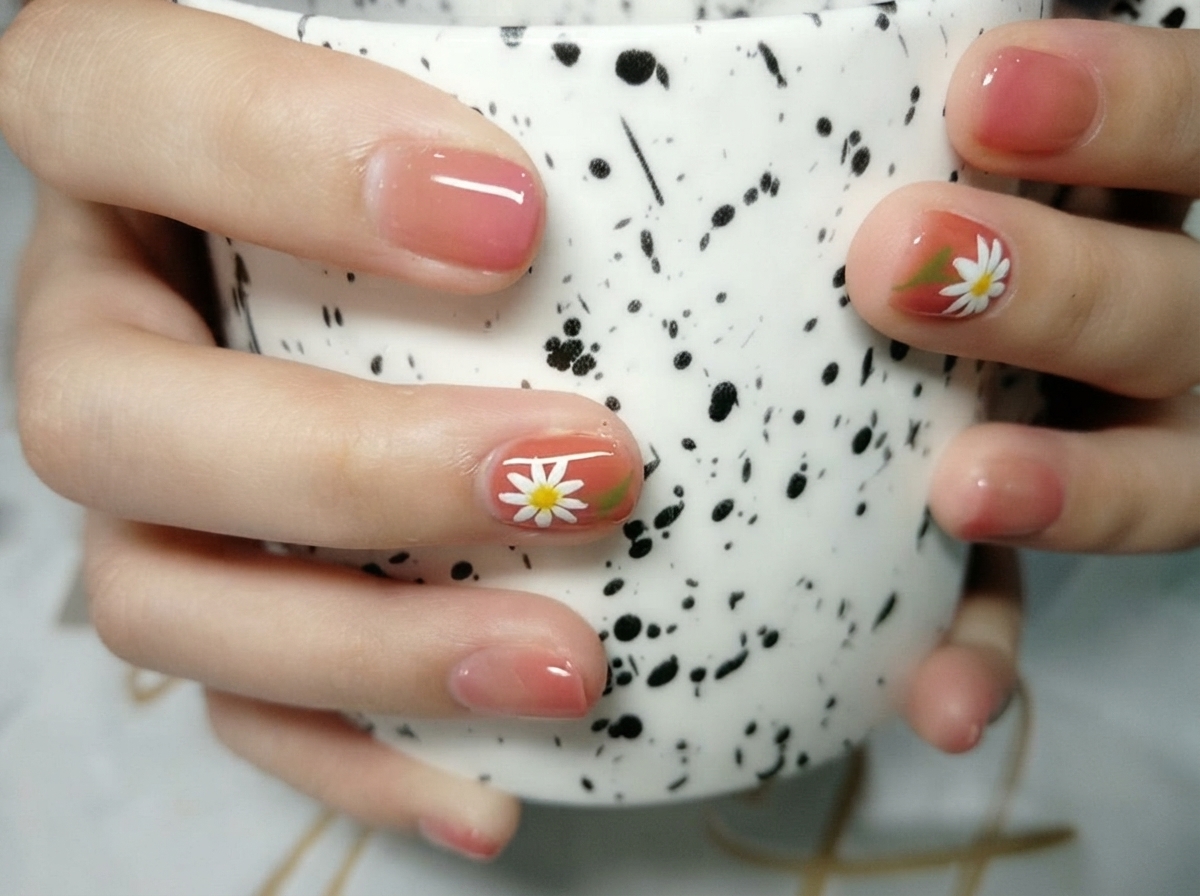 Macro shot of a detailed white daisy nail art design on a warm-toned background with bright lighting.