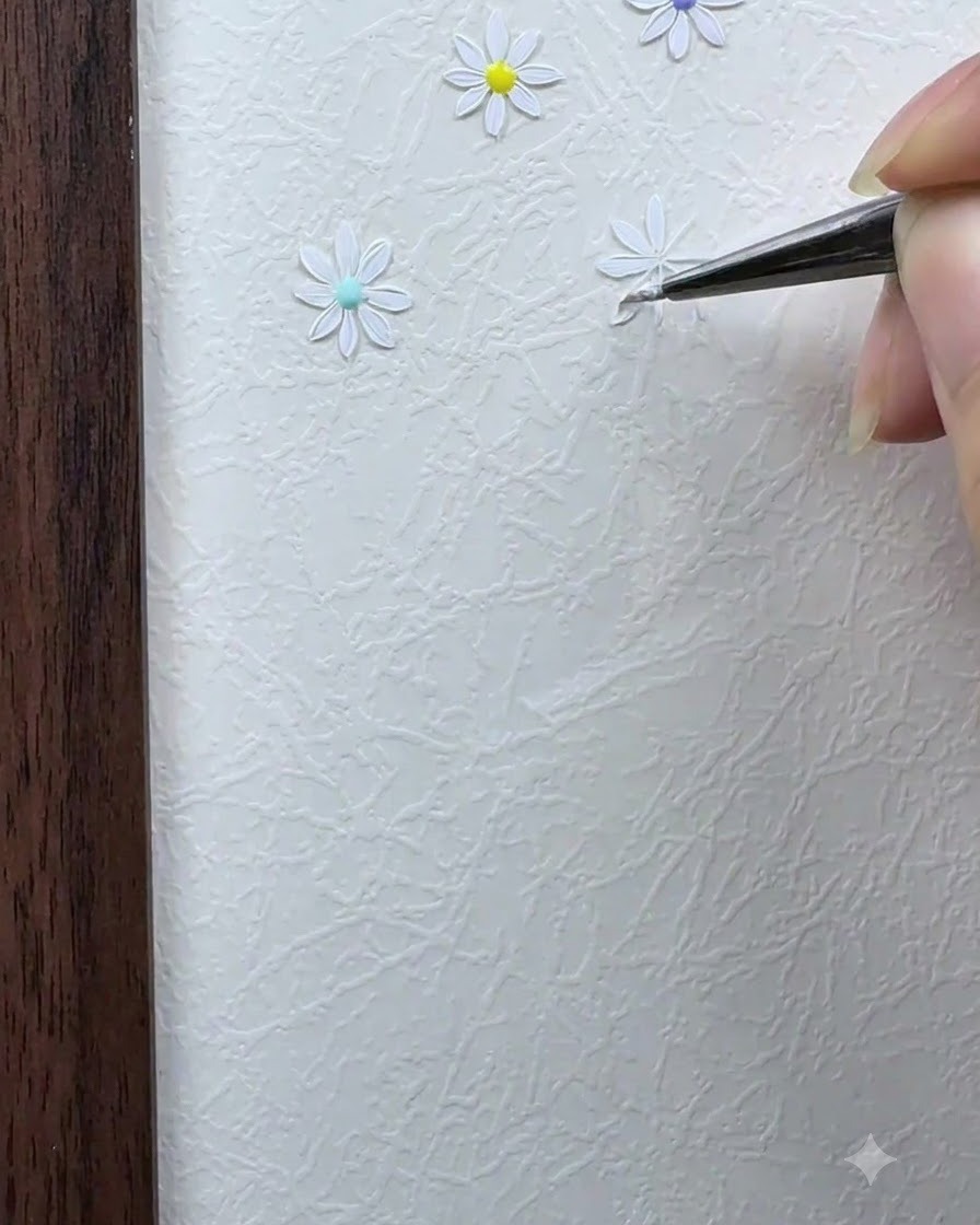 A detail brush painting the second white petal directly opposite the first petal.
