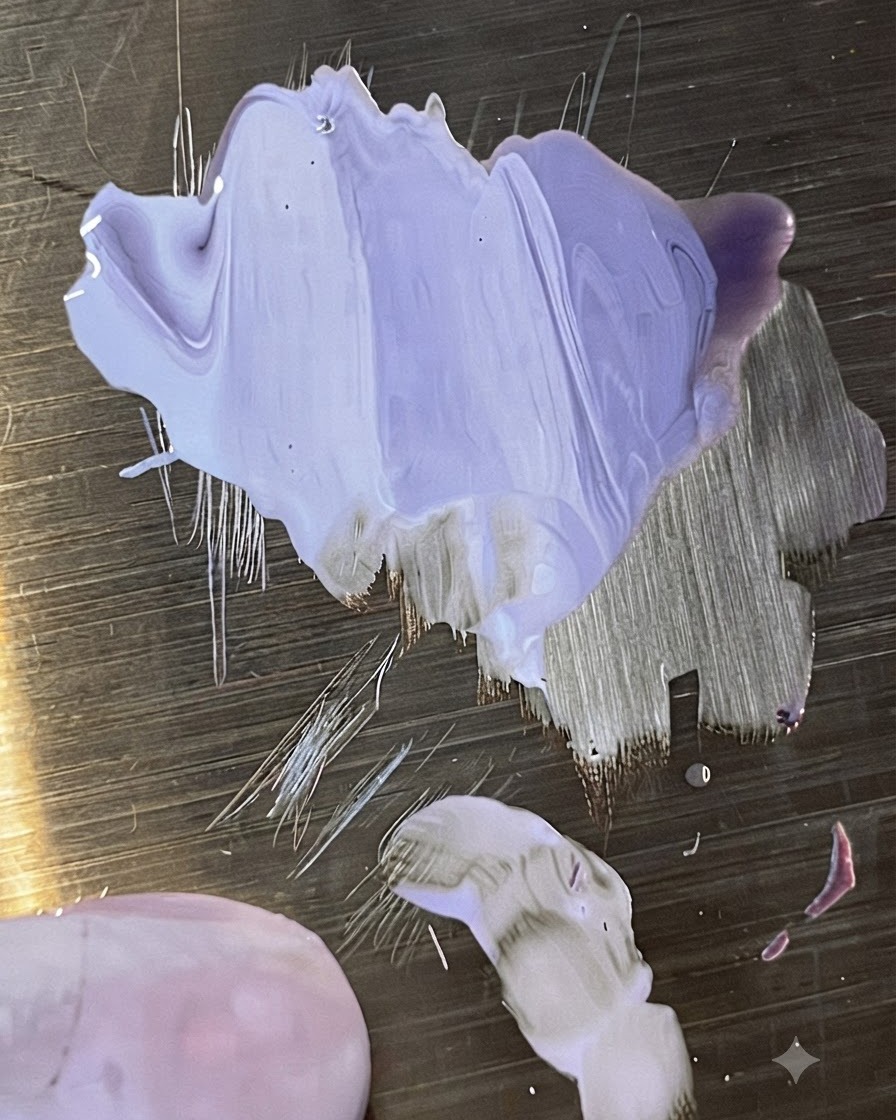 A clear false nail tip displaying a smooth light purple gradient blend.