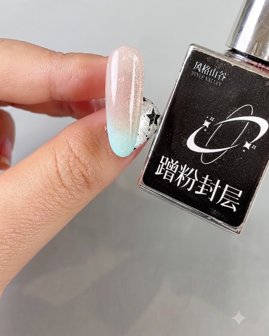 A hand holding a black Style Valley product bottle next to a cured gradient cat eye nail.
