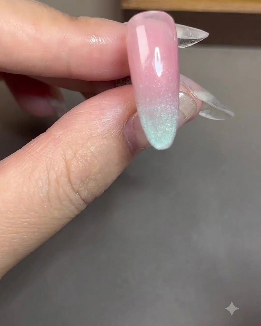 A cylindrical magnet held close and parallel to a nail coated with blue cat-eye gel.