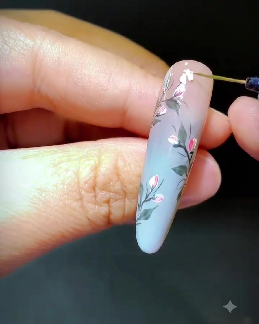A tool placing crushed shell fragments onto wet gel to form a floral design.