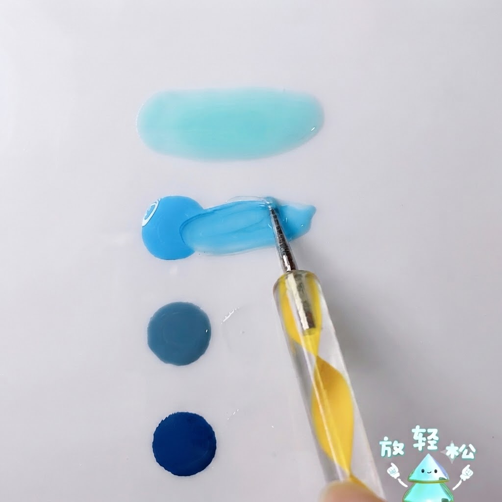 A dotting pen mixing bright sky blue gel with transparent gel on a white palette surface.