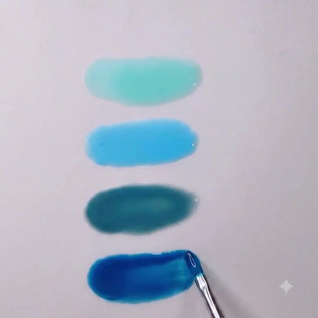 A close-up of a nail brush smoothing out the edges of a deep Morandi blue translucent gel puddle.
