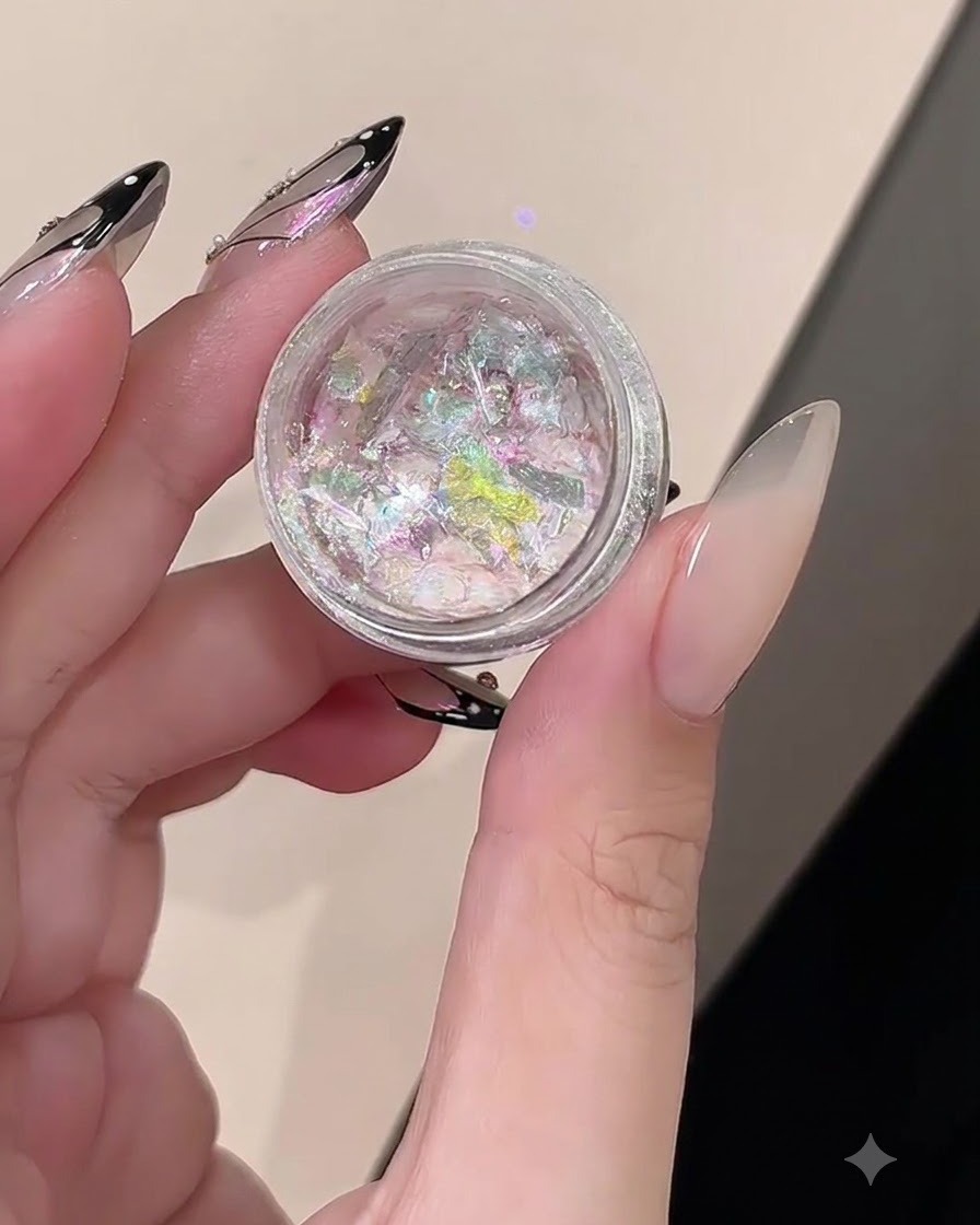 A jar containing iridescent pink and purple reflective opal flakes.