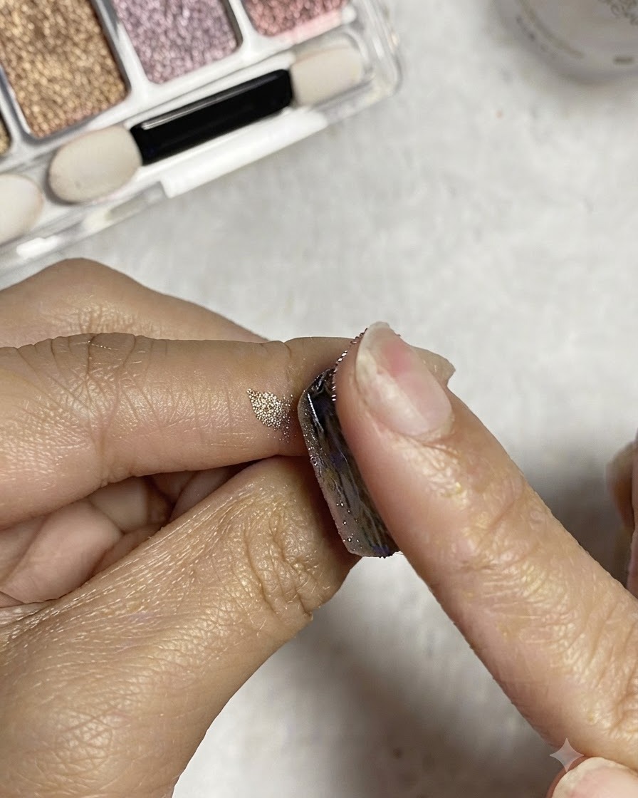 A finger wiping excess silver powder off the nail surface with alcohol.