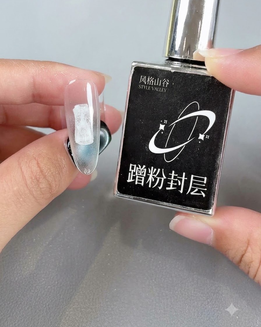 A hand holding a black product bottle next to a clear nail tip showing a cured sealing coat layer.