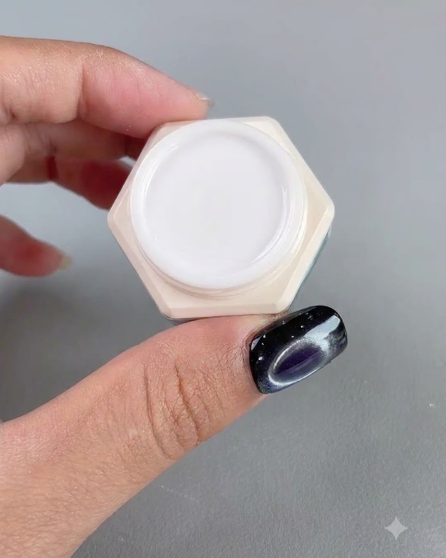 A jar of high-transparent amber nail gel shown next to a manicured finger.
