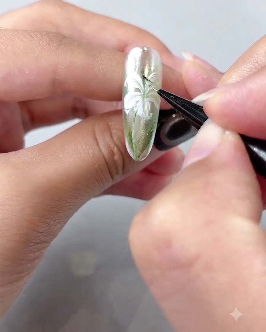 A detailed close-up of a fine brush painting dark stamen lines inside the center of the lily.