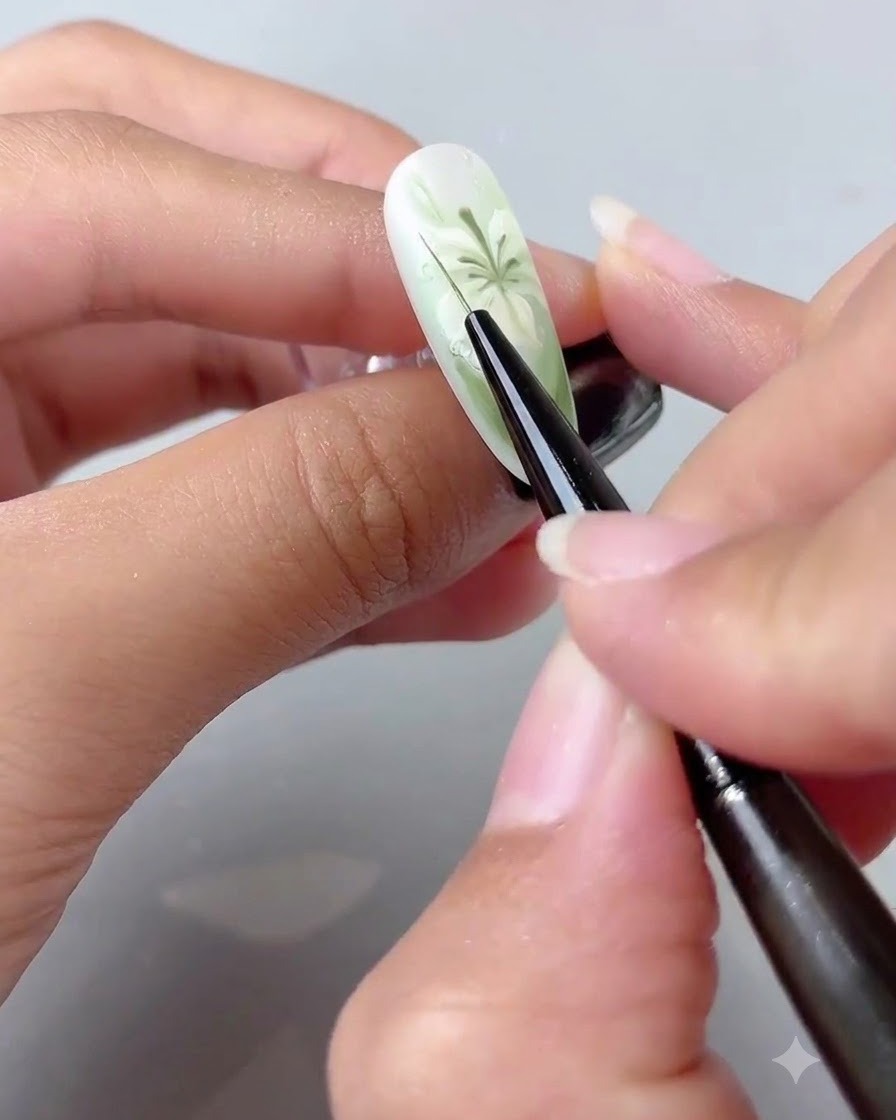 A fine liner brush applying small droplets of clear 3D shaping gel onto the painted nail surface.