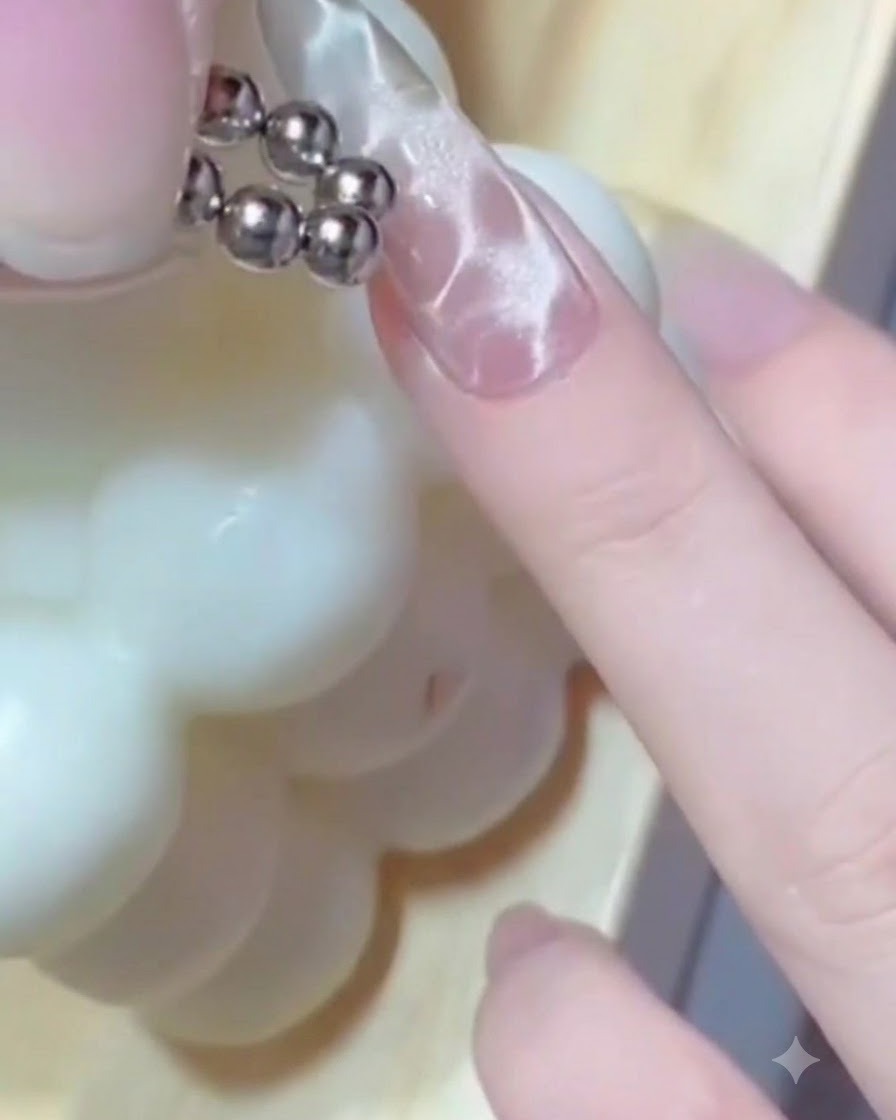 A fingernail positioned under a compact UV/LED lamp during the gel curing process.