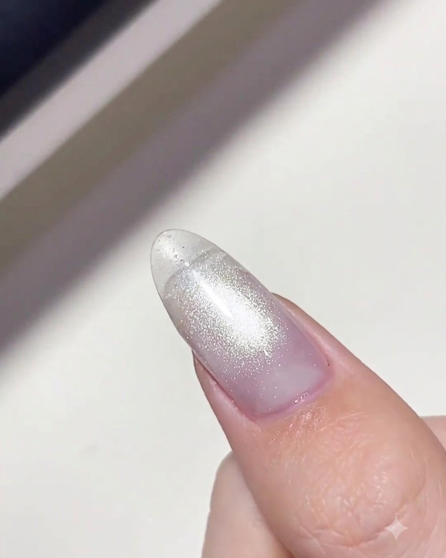 A lint-free wipe being used to clean the surface of a cured nail.