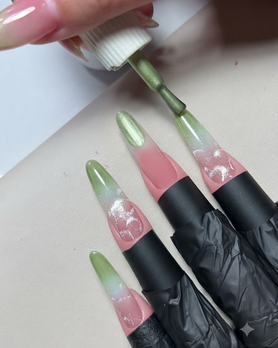 A gel polish brush applying a layer of vibrant green polish onto the free edge of a practice nail extension.