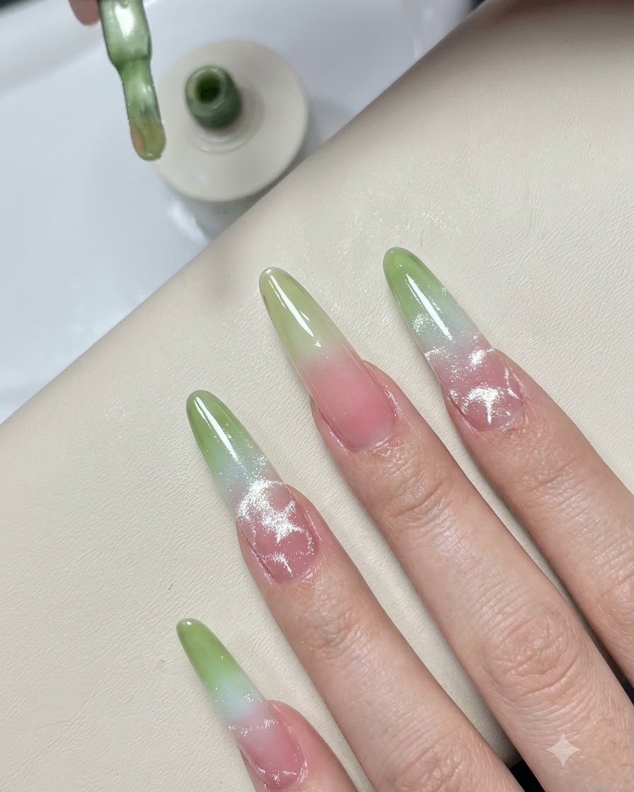 A polish brush depositing a small extra touch of green gel onto the tip of the practice nail.