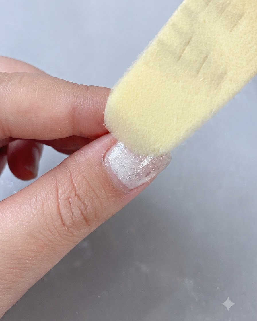 A buffer file smoothing out the surface of a finished gel nail.
