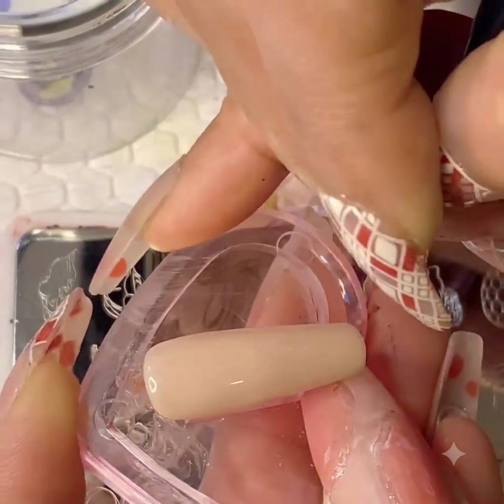 A close-up view of a fine brush painting skin color onto a silicone stamper head.