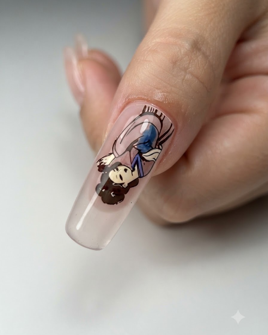 A nail art brush refining the clothing and skin tone lines of a completed character decal on a nail.