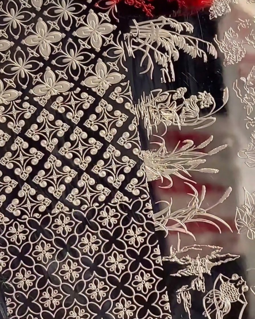 A stamping plate showing various intricate floral patterns and background textures.