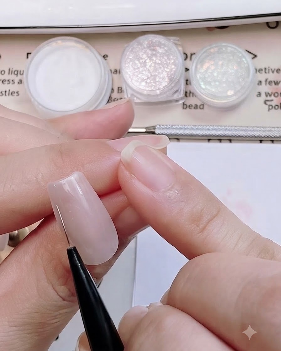 A fine nail art brush drawing thin outline guides for a sweater knit pattern on a matte pink nail.