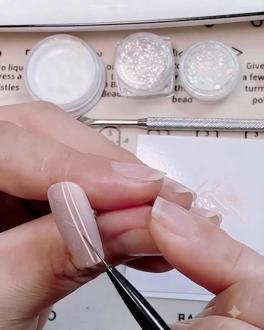 A fine nail brush drawing parallel vertical lines down the center of a sweater knit nail design.