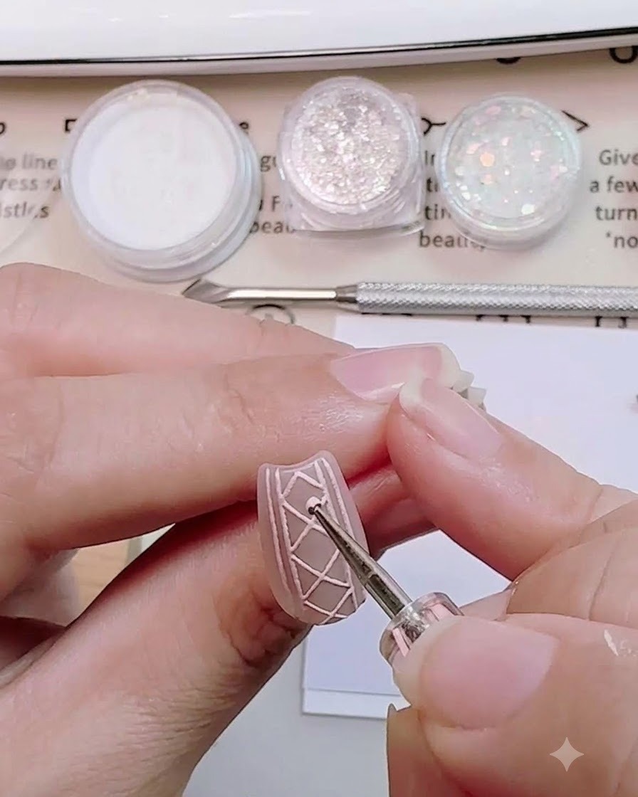 A dotting tool placing a small dot of white sugar powder onto the cross-section of a 3D sweater nail design.